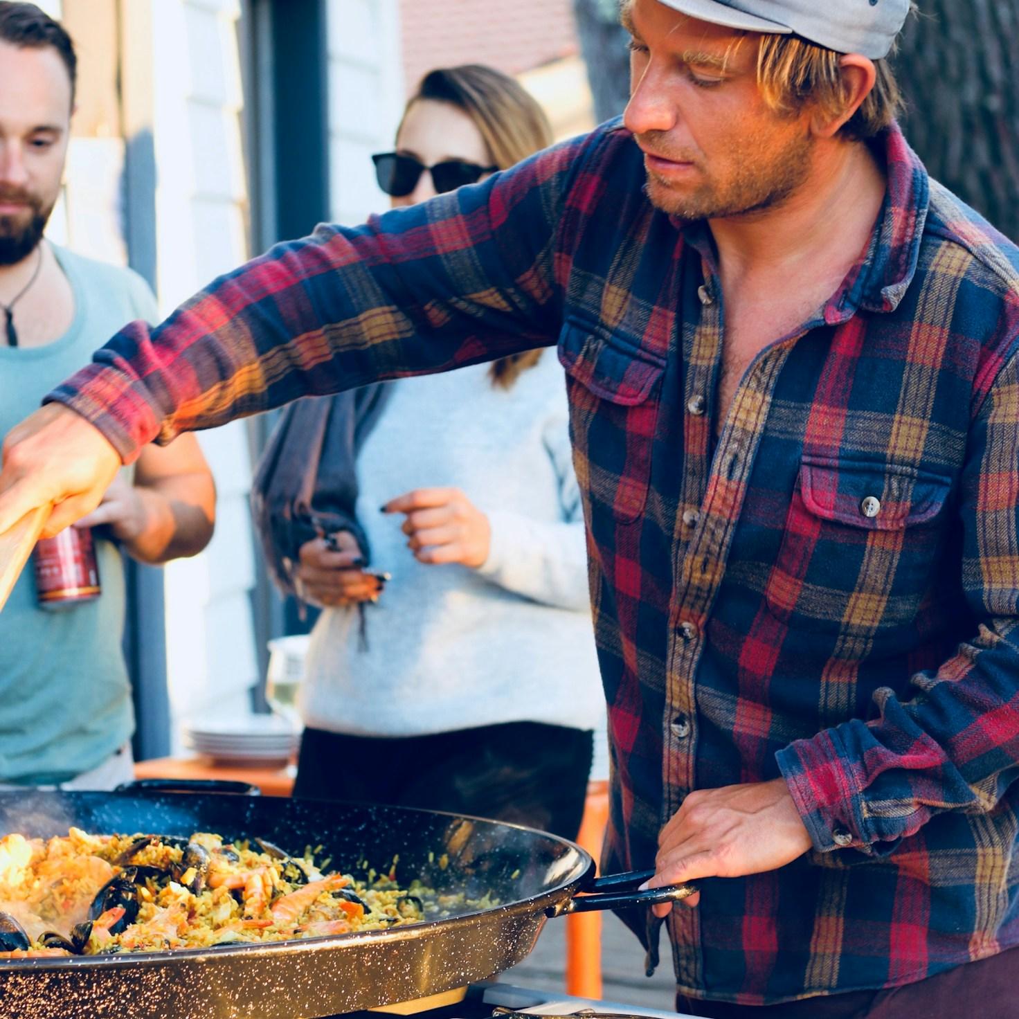 Community members collaborating in a modern kitchen space, sharing recipes and cooking techniques